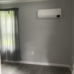 image of air conditioning wall unit with hardwood flooring