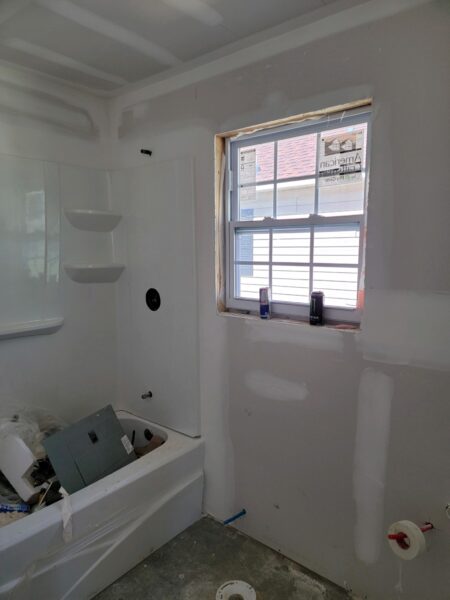 image of bathtub with window and drywall construction project
