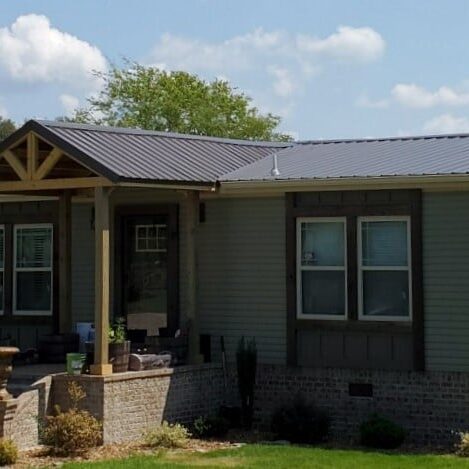 home with finished metal roof and covered front porch