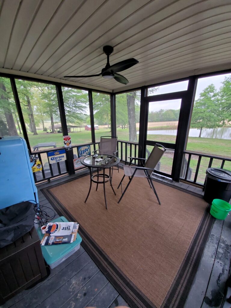interior of enclosed patio with ceiling fan and patio furniture