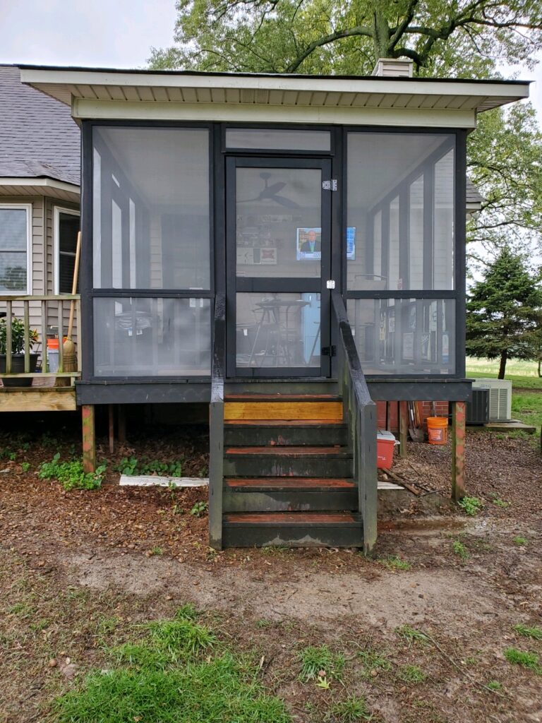 exterior of enclosed patio with stairs leading up to the door