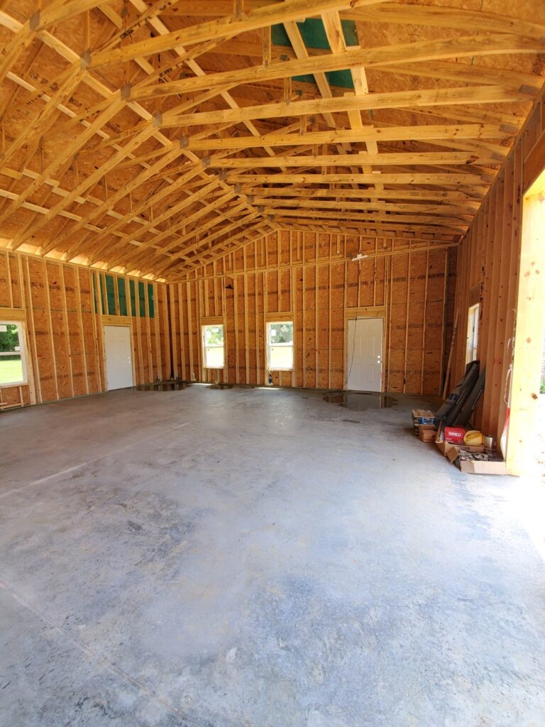 interior of garage under construction with beams and walls visible